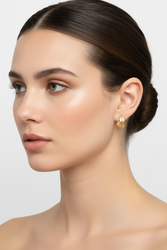 Caucasian European model wearing Golden Wave Earrings - adjusted size
